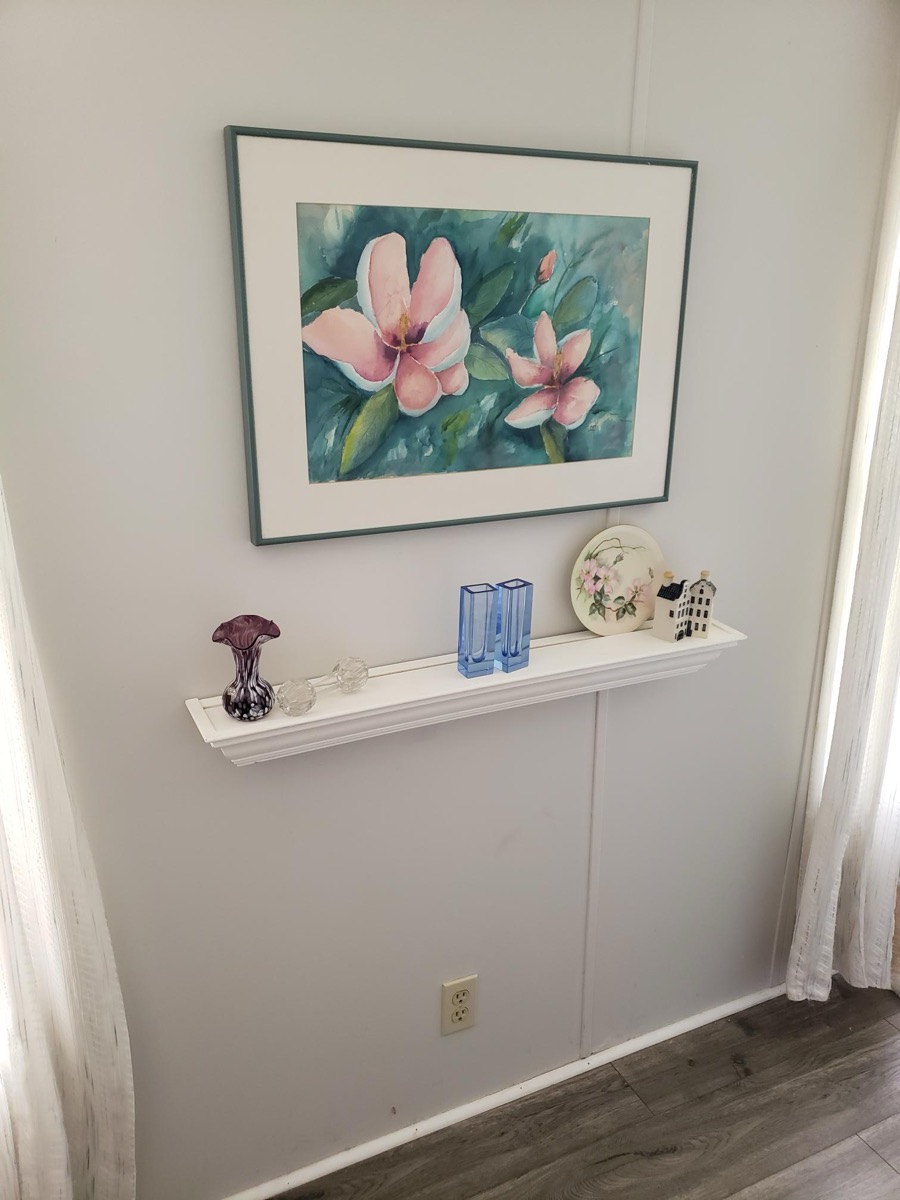 Bedroom display shelf with watercolor artwork